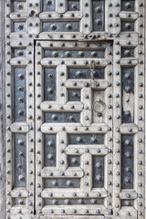 close up view of ancient broken medieval door with nails made of steel and wood
