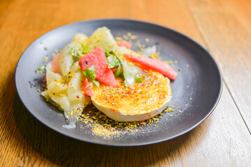 Watermelon and cucumber cheese salad with mint and melon. Watermelon summer menu, seasonal meal concept.