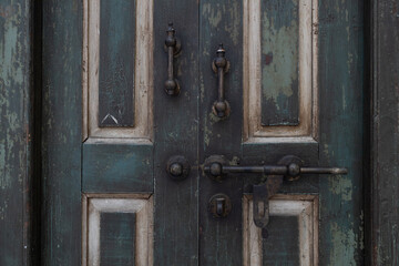close up view of ancient wooden door with rusty old slide or tower bolt