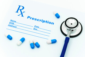 A stethoscope and medicine capsules on a prescription paper.  A medical concept for diagnosis and therapy