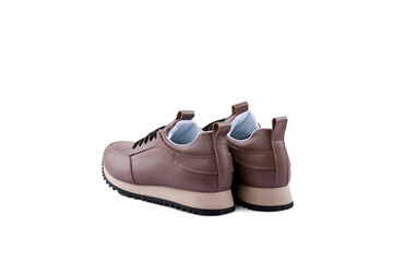 The pair of unisexs brown leather sneakers isolated on white background