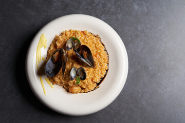 Risotto with mussels and rice in a white plate. Spanish cuisine, Seafood Paella
