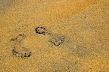 Fototapeta na wymiar Fussspuren im Sand