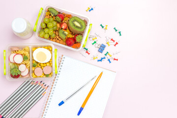 Notebooks and pen, pencils. School box with fruits and nuts.
