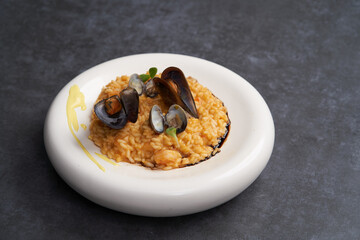 Risotto with mussels and rice in a white plate. Spanish cuisine, Seafood Paella