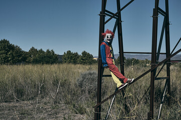 Fototapeta na wymiar scary evil clown on an abandoned billboard