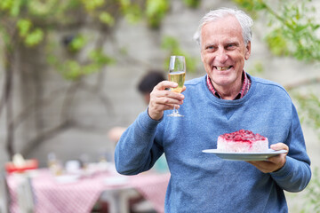Senior with champagne glass and a piece of birthday cake