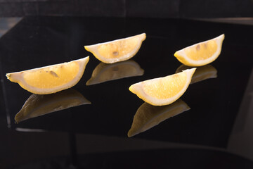 Lemon slices on a black background close - up