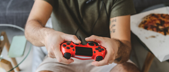 Happy man playing online video games - Young gamer having fun on new technology console - Gaming entertainment and youth millennial generation lifestyle concept