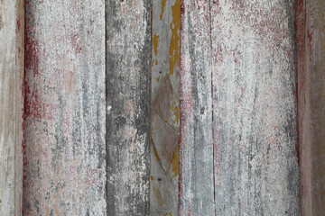 Fototapeta premium Old wooden door For more than eighty years in the sun and for a long time it is deteriorating with time and the color is peeling off the wood.