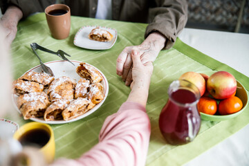 Elderly couple holding hands