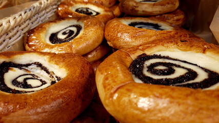 Sour cream buns with poppy seeds closeup background. Sweet pastry. Apetite buns. Smetannik.