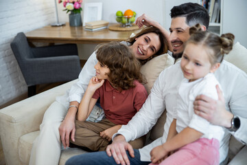 Family hugging on the couch