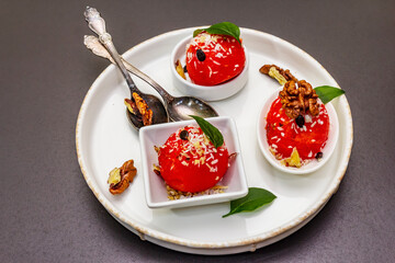 Watermelon ice cream or sorbet with coconut flakes, walnuts and fresh basil leaves