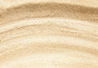 Fototapeta na wymiar Wavy beige sand texture background close up