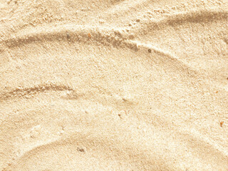 Fototapeta na wymiar Wavy beige sand texture background close up