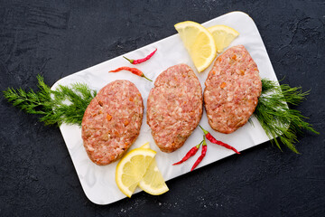 Uncooked cutlet with beef minced meat and cabbage
