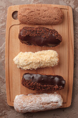 French eclairs. Chocolate and cream eclairs for coffee. Sweets for a coffee break