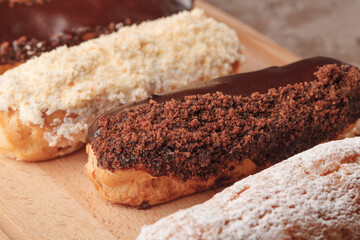 French eclairs. Chocolate and cream eclairs for coffee. Sweets for a coffee break