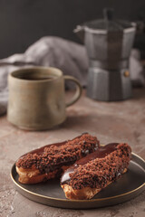 French eclairs. Chocolate and cream eclairs for coffee. Sweets for a coffee break