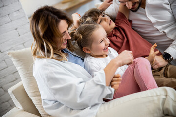 Mother tickling, playing, joking with kids