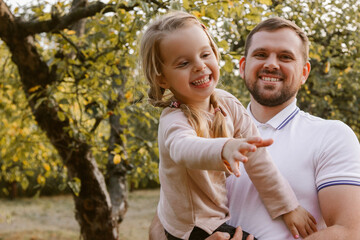 Young man holding little girl