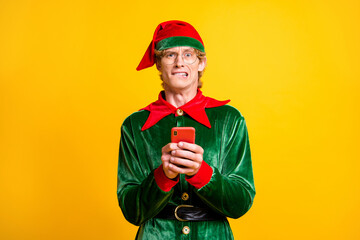 Portrait of his he nice attractive worried confused funny guy elf using gadget app 5g blogging browsing post comment feedback isolated over bright vivid shine vibrant yellow color background