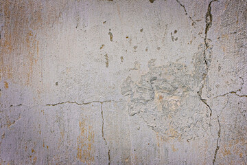 Gray plastered concrete wall with cracks.  Industrial building. Grunge. Is an excellent choice for your design and texture background. Space for text.