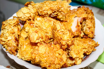 Fried pieces of chicken fillet in breadcrumbs, which are in the plate.