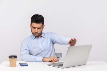 Don't want to look! Confused businessman sitting office workplace, showing stop to laptop screen,...