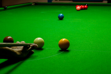 Man playing snooker balls on green snooker table