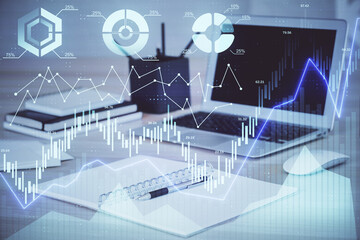 Stock market graph and table with computer background. Double exposure. Concept of financial analysis.