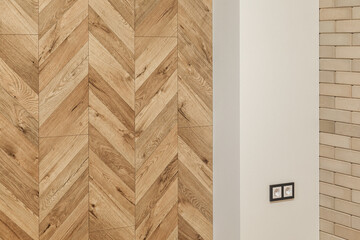 part of living room in warm colors, wall imitating wooden parquet, brick wall