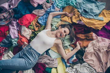 High angle above view photo of cheerful funny lady stay home spring cleaning household lying among...