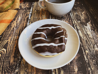 Cup of coffee and chocolate doughnut