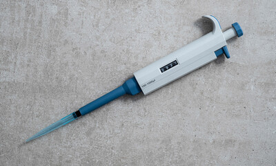 Automatic pipette isolated on concrete background stock photo