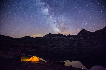 Fototapeta na wymiar Summer night under Milky way in Ibon De Estanes lake, Aragon Pyrenees, Spain
