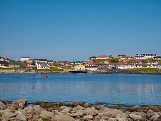 Fototapeta na wymiar The coastal community of Hamnavoe on the west of Mainland, Shetland, Scotland, UK - taken from Fugla Ness on a sunny day in summer
