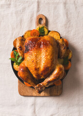 Fall thanksgiving table with roasting chicken or turkey on light tablecloth