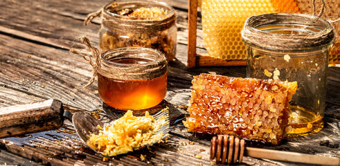 Sweet honeycomb on wooden table. Honey background. Beekeeping concept. Long banner format