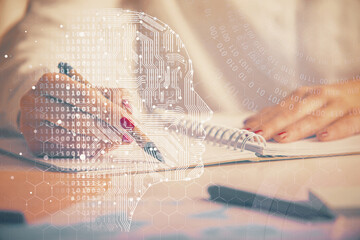 Double exposure of woman's writing hand on background with brain hologram. Concept of brainstorming.