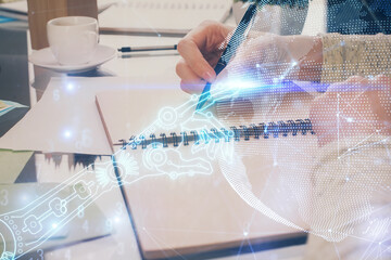 Technology theme hologram over woman's hands taking notes background. Concept of Tech. Double exposure