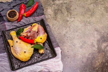 Raw BIO organic chicken legs with fresh vegetables and spices