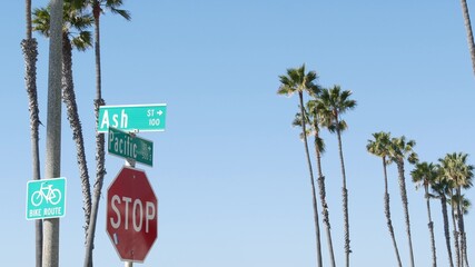 Pacific street road sign on crossroad, route 101 tourist destination, California, USA. Lettering on intersection signpost, symbol of summertime travel and vacations.Signboard in city near Los Angeles