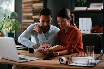 Businessman and businesswoman in office. Two friends drinking coffee while working on the project..
