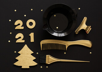 Accessories for hair coloring, numbers 2021 and a Golden Christmas tree. Black and gold color items, new year theme for hairdressers