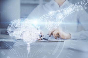 Fototapeta premium Multi exposure of writing hand on background with brain hologram. Concept of self learning.