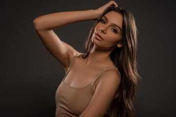 Fototapeta premium Beautiful girl posing on grey background. Studio Isolated