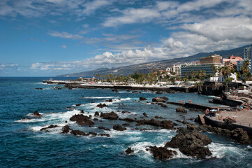 Picturesque views of the town flanked on one side by the volcanic mountains and valleys and surrounded by the popular hotels, shops and restaurants, Puerto de la Cruz, Tenerife, Canary Islands, Spain