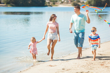 Happy family having fun on the beach. Summer concept